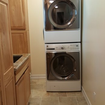 Construction Solutions - This was a small front porch that we converted to a laundry room with full size appliances stacked and a utility sink. - General Contractors Near Me