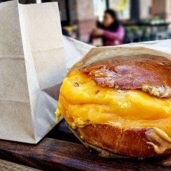 Eggslut - The Fairfax. The eggs are cooked with chives and caramelized onions and placed in a toasty brioche bun and topped off with sricha mayo. - New American Near Me - Glendale, California