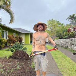 Aina Terra Permascapes - Owner Joey Miller installing Soil Plus Mac Nut Compost aka the hamakua at a Clients in Kalaoa
