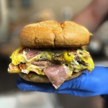 Sunrise Deli - a hand holding a sandwich - Delis Near Me - West Haven, Connecticut