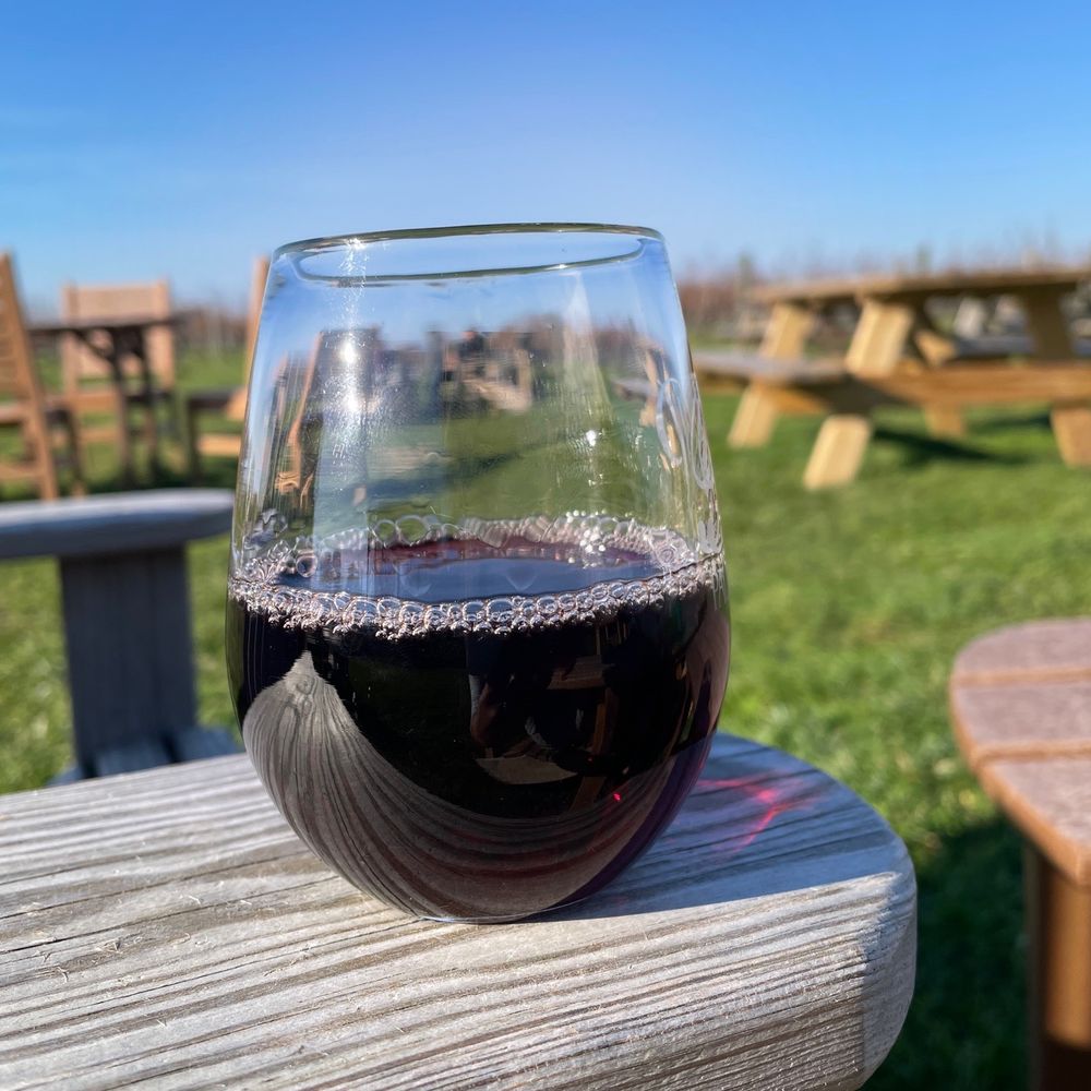Palmer Vineyards - a glass of red wine on a picnic table - Wineries Near Me - Aquebogue, New York Palmer Vineyards - a glass of red wine on a picnic table - Wineries Near Me - Aquebogue, New York