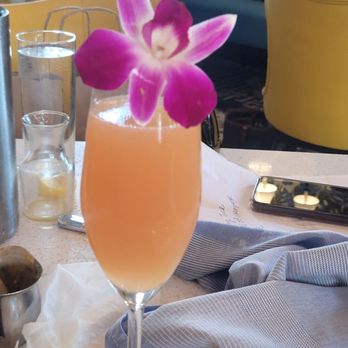Crack'D Brunch - Edible flower with orange juice mimosa - Breakfast & Brunch Near Me - New Orleans, Louisiana