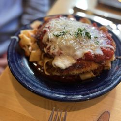 Ticino - Pappardelle with Bolognese sauce, topped with Chicken Parmesan.