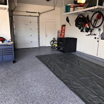 Pro coatings - a garage with a tarp covering the floor - Waterproofing Near Me Pro coatings - a garage with a tarp covering the floor - Waterproofing Near Me