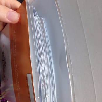 Walgreens - a person holding a stack of papers - Drugstores Near Me - Warwick, Rhode Island