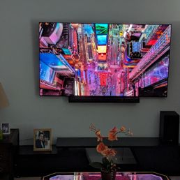 Wall-mounted 77" TV on a tilted bracket and the assembly of a retractable TV console. Wall-mounted 77" TV on a tilted bracket and the assembly of a retractable TV console.