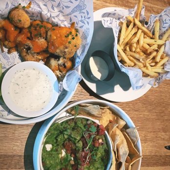 Earls Kitchen + Bar - Guacamole and chips, Buffalo cauliflower, Garlic fries - New American Near Me - McLean, Virginia