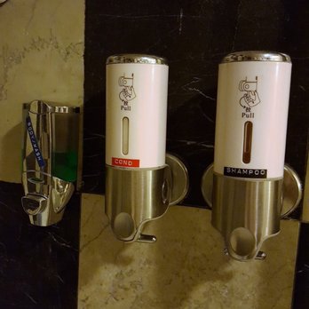 Ocean Inn & Suites - Toiletry "dispensers" in shower- no idea what the products are being used. - Hotels Near Me - St. Simons Island, Georgia