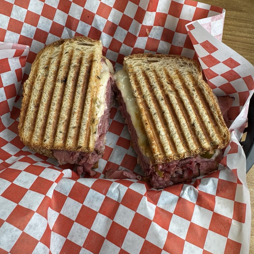 Rueben- pastrami, thousand island, Swiss, sauerkraut on a rye bread. Rueben- pastrami, thousand island, Swiss, sauerkraut on a rye bread.