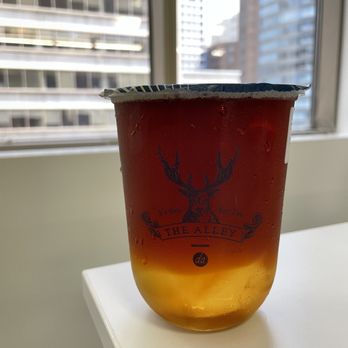 The Alley - a cup of honey on a table in front of a window - Bubble Tea Near Me - Toronto, Ontario The Alley - a cup of honey on a table in front of a window - Bubble Tea Near Me - Toronto, Ontario