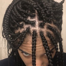Crooked parts and different size braids. My 12 year old cousins braids better than this. Crooked parts and different size braids. My 12 year old cousins braids better than this.