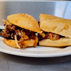 Trinity Bistro And Deli - Double Meat Combo Sub (Italian Sausage, Pulled Pork, House-House-crafted BBQ Sauce, Crispy Onions on Sourdough Roll)