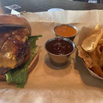 Brick Top's Pub - Bucktown Burger Cheddar, Bacon, Caramelized Onions,  BBQ  Fries with side bbq and wing sauce - Burgers Near Me - Austin, Texas