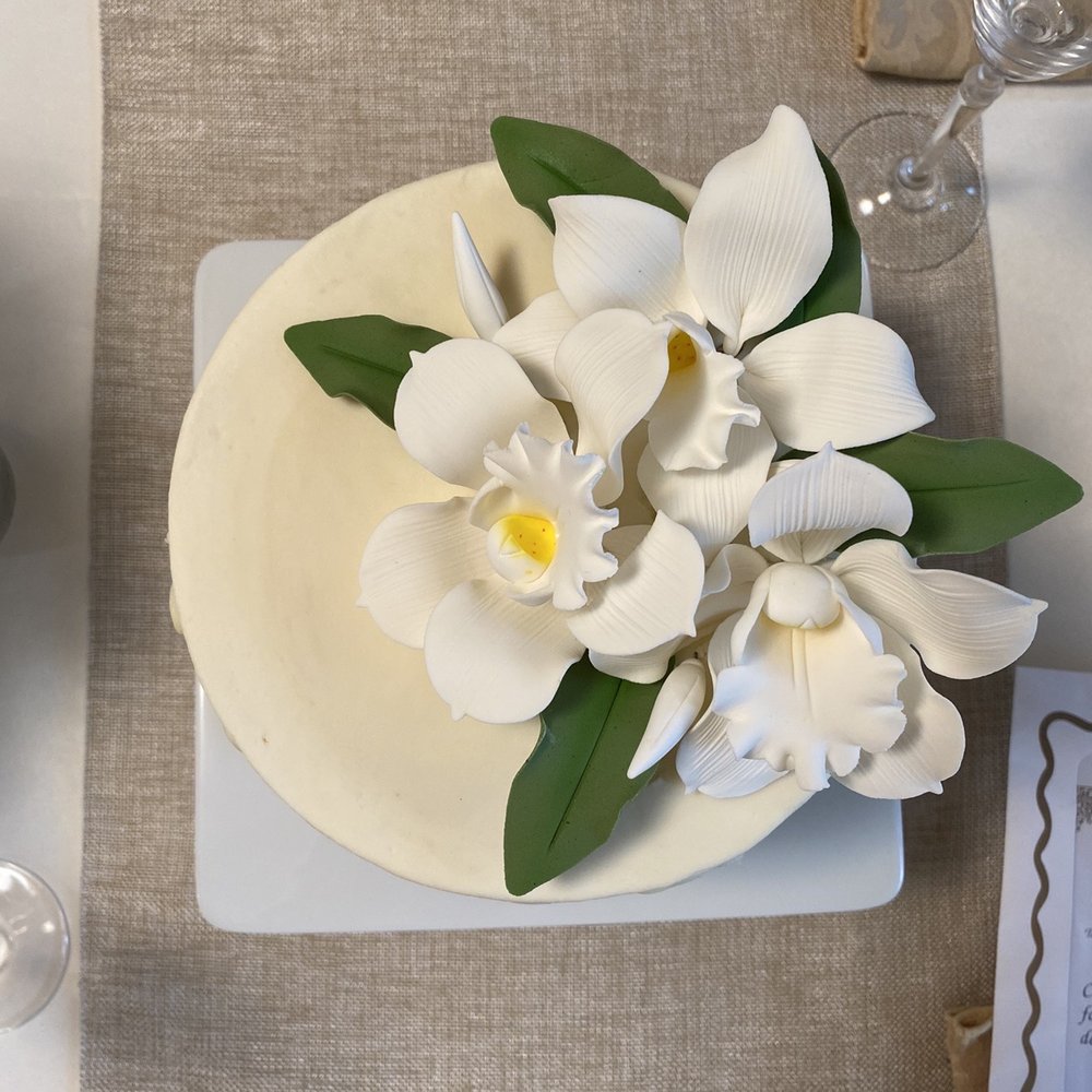 The Confectionary Cupboard - a cake with white flowers - Bakeries Near Me - Mentor, Ohio