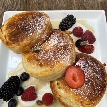NOMO Kitchen - Brunch Lemon, Ricotta, Pancakes Mixed Berries, Candied Pistachios, Maple Syrup - New American Near Me - New York, New York