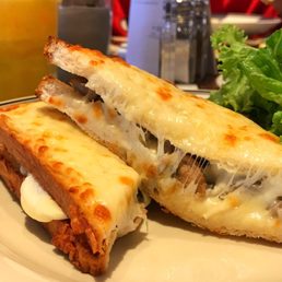 Croque Champignon - delicious bread covered with some cream sauce and loads of cheese with mushrooms at the center Croque Champignon - delicious bread covered with some cream sauce and loads of cheese with mushrooms at the center