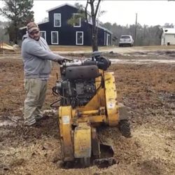 Hughes Tree Care - In this photo, the business owner is grinding a tree stump.