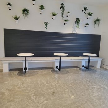 Overtown Nutrition - a row of tables with planters on the wall - Juice Bars & Smoothies Near Me - Memphis, Tennessee Overtown Nutrition - a row of tables with planters on the wall - Juice Bars & Smoothies Near Me - Memphis, Tennessee