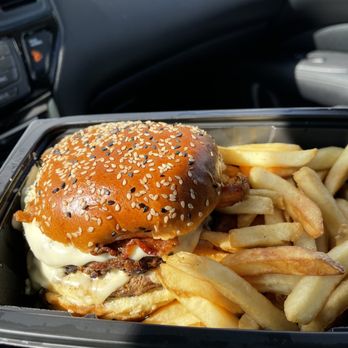 Miller's Ale House - $12.29 | Black & Blue Burger - Peppered bacon, blue cheese crumbles, melted white American cheese, blue cheese sauce and garlic-lime crema. - Sports Bars Near Me - Bel Air, Maryland