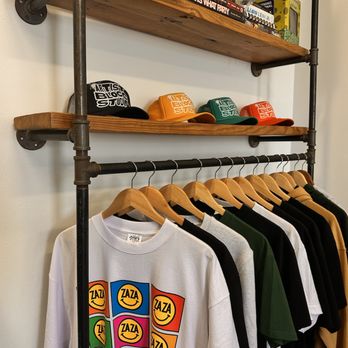 Artist Blocc Studio - Sample rack - Showcasing blank options as well as print styles available. - Screen Printing/T-Shirt Printing Near Me Artist Blocc Studio - Sample rack - Showcasing blank options as well as print styles available. - Screen Printing/T-Shirt Printing Near Me