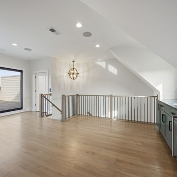 DJK Custom Homes - Custom rowhome media loft designed for great gatherings, featuring an open layout and a built-in wet bar for easy entertaining. - General Contractors Near Me - Naperville, Illinois