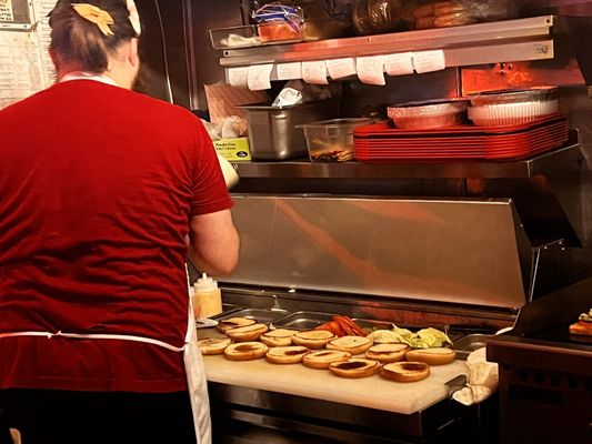 Photo of Dino's - Nashville, TN, US. a man preparing food in a restaurant kitchen