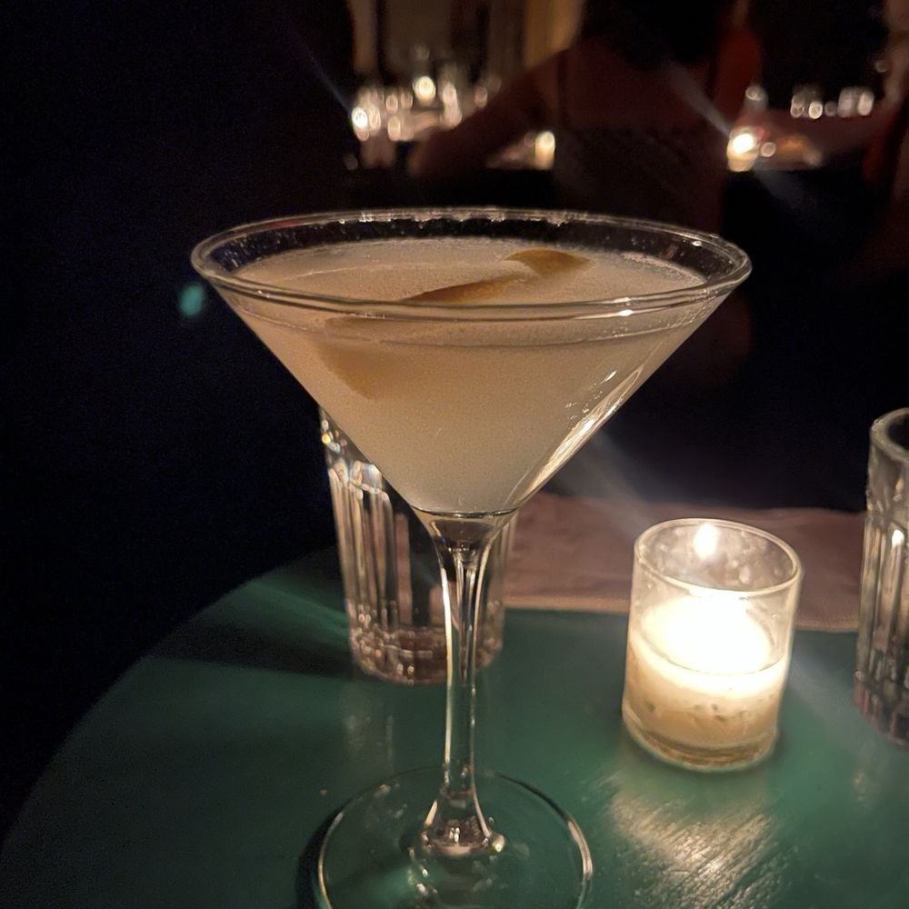 a glass of martini on a table a glass of martini on a table