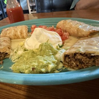 The Point Tlaquepaque - Chimichanga: one beef, one chicken; lettuce, sour cream, tomatoes, and guacamole; melted cheese sauce. Big enough to share for lunch. - Mexican Near Me - Cambridge, Ohio The Point Tlaquepaque - Chimichanga: one beef, one chicken; lettuce, sour cream, tomatoes, and guacamole; melted cheese sauce. Big enough to share for lunch. - Mexican Near Me - Cambridge, Ohio