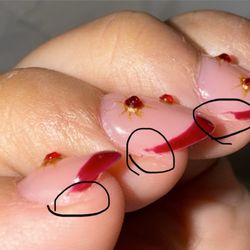 Lucy & Kelly’s Nail Salon - Unfinished tips. Can see the missing top coat to protect the gems.