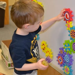 Happy Time Day Care Center - As the child plays with gears he is learning about motion, magnets, and how to be creative