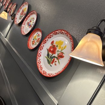 Absolute Thai & Noodles - a row of plates on a wall - Thai Near Me - Crestview, Florida