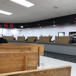 Department of Motor Vehicles - There are 7 employees not working at all. They are talking in a group - rearranging their papers, setting up there coffee