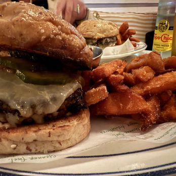 Basic Kitchen - NAUGHTY BURGER brasstown farm grass-fed beef, double patty smash, aged white cheddar, griddled onions, dijonnaise, bread and butter pickle - New American Near Me - Charleston, South Carolina