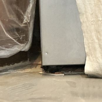 Town Center Floors - Here is the exposed section of the refrigerator where I found the new dent, after the workers finished hammering the old tiles. - Flooring Near Me - Coppell, Texas Town Center Floors - Here is the exposed section of the refrigerator where I found the new dent, after the workers finished hammering the old tiles. - Flooring Near Me - Coppell, Texas