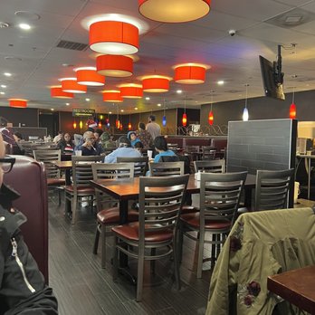 Feast - a man sitting at a table in a restaurant - Buffets Near Me - Oklahoma City, Oklahoma