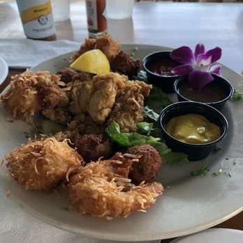 Gramma Dot's - Appetizer combo- crabmeat balls, fried oysters, coconut shrimp with cocktail sauce, yellow mustard, and an ?Apple cinnamon sauce. - Seafood Near Me - Sanibel, Florida Gramma Dot's - Appetizer combo- crabmeat balls, fried oysters, coconut shrimp with cocktail sauce, yellow mustard, and an ?Apple cinnamon sauce. - Seafood Near Me - Sanibel, Florida