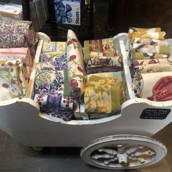 Fairy Cross Bottle Shop - a wheelbarrow full of fabric - Wine Bars Near Me - Murphy, North Carolina Fairy Cross Bottle Shop - a wheelbarrow full of fabric - Wine Bars Near Me - Murphy, North Carolina
