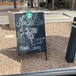 a chalkboard sign in front of a coffee shop a chalkboard sign in front of a coffee shop