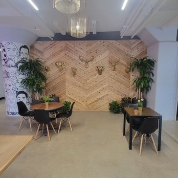 Darnel’s Cakes - a dining area with a wooden wall - Bakeries Near Me - Philadelphia, Pennsylvania