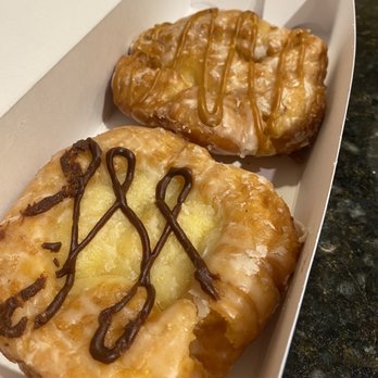 Sublime Doughnuts - Caramel Apple fritter in the back, banana peanut butter fritter in the front - Donuts Near Me - Atlanta, Georgia Sublime Doughnuts - Caramel Apple fritter in the back, banana peanut butter fritter in the front - Donuts Near Me - Atlanta, Georgia