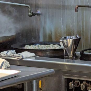 Xiao Chi Jie - Pan of Sheng Jian Bao Cooking - Shanghainese Near Me - Bellevue, Washington Xiao Chi Jie - Pan of Sheng Jian Bao Cooking - Shanghainese Near Me - Bellevue, Washington