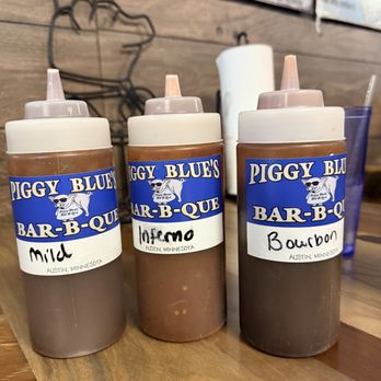 Piggy Blue's Bar-B-Que - sauces on table - Barbeque Near Me - Austin, Minnesota Piggy Blue's Bar-B-Que - sauces on table - Barbeque Near Me - Austin, Minnesota