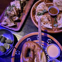 Pretzel, quesadilla, olives, and grilled Brie cheese