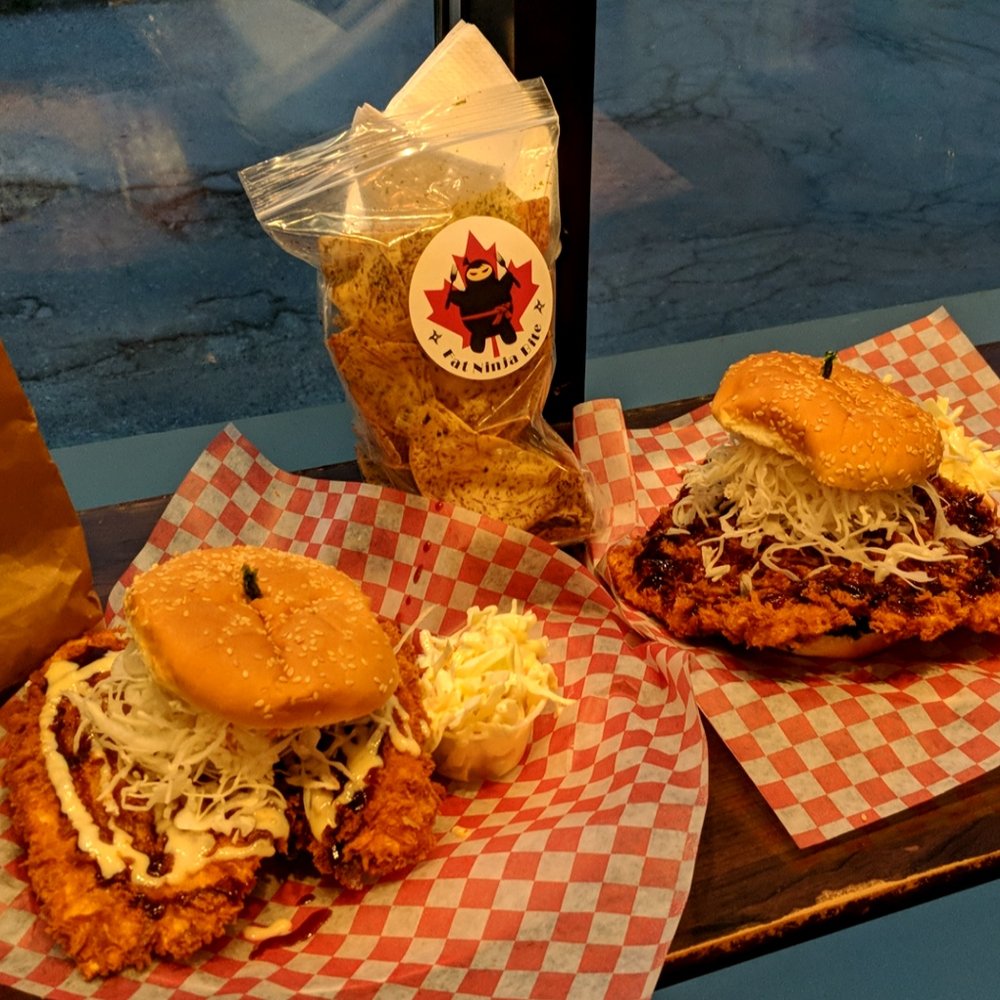 Fat Ninja Bite - Left: fish katsu burger, Right: chicken katsu burger, middle: taro chips - Japanese Near Me - Toronto, Ontario Fat Ninja Bite - Left: fish katsu burger, Right: chicken katsu burger, middle: taro chips - Japanese Near Me - Toronto, Ontario