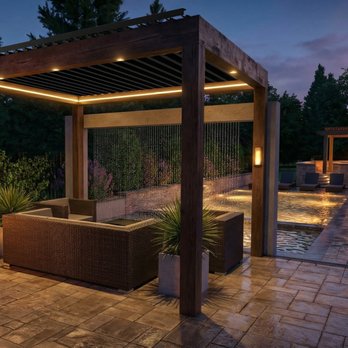 Allscape Patio & Landscape - Custom wood and aluminum motorized pergola on a luxury paver patio, featuring a water curtain, swimming pool, and multiple fire features. - Landscaping Near Me Allscape Patio & Landscape - Custom wood and aluminum motorized pergola on a luxury paver patio, featuring a water curtain, swimming pool, and multiple fire features. - Landscaping Near Me