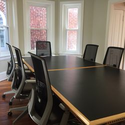 CoWork 414 - The conference room seats 8-10 comfortably and is available to members for booking.