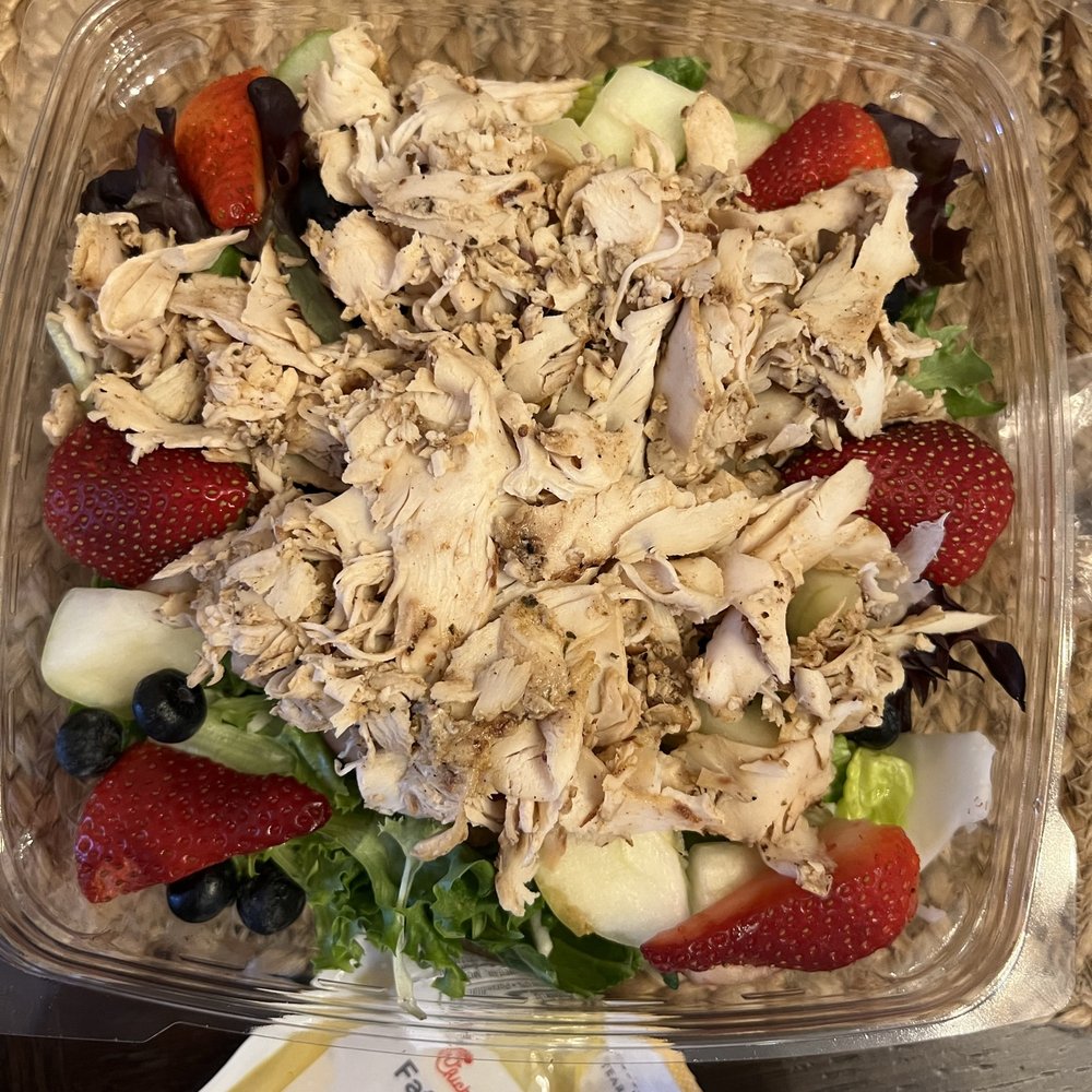 ows a salad in a plastic container