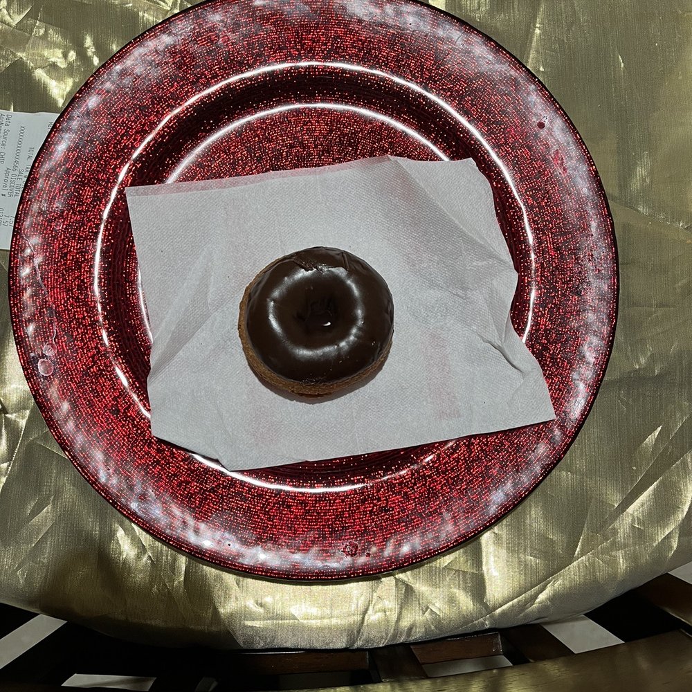 a chocolate donut on a plate