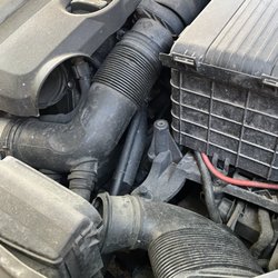 AAMCO Transmissions & Total Car Care - how the air intake was left. Battery plastic is also not in the correct direction, and is under the installed battery