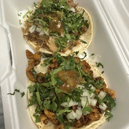 Top carnitas taco. Bottom pastor taco